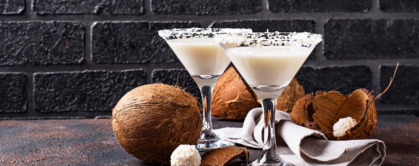 Two white cocktails with coconut sprinkles