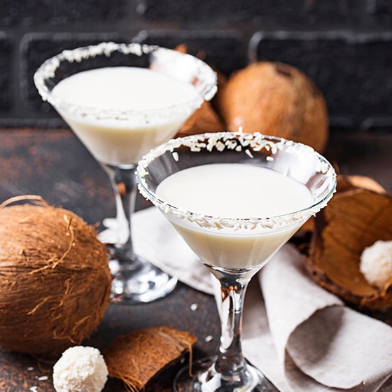 Two cocktails with coconut sprinkles from above