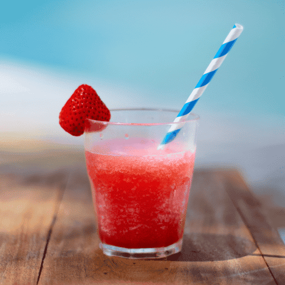 strawberry daiquiri cocktail with a strawberry as garnish and a striped straw