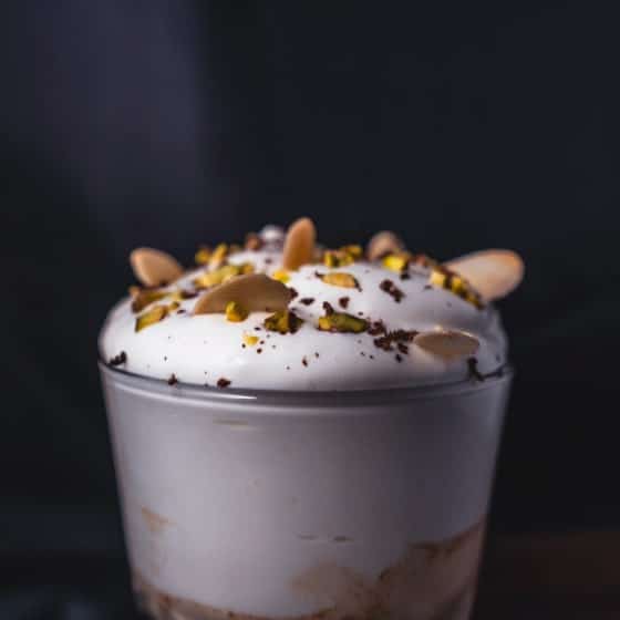 Boozy Christmas Coffee cocktail with festive decorations in a glass